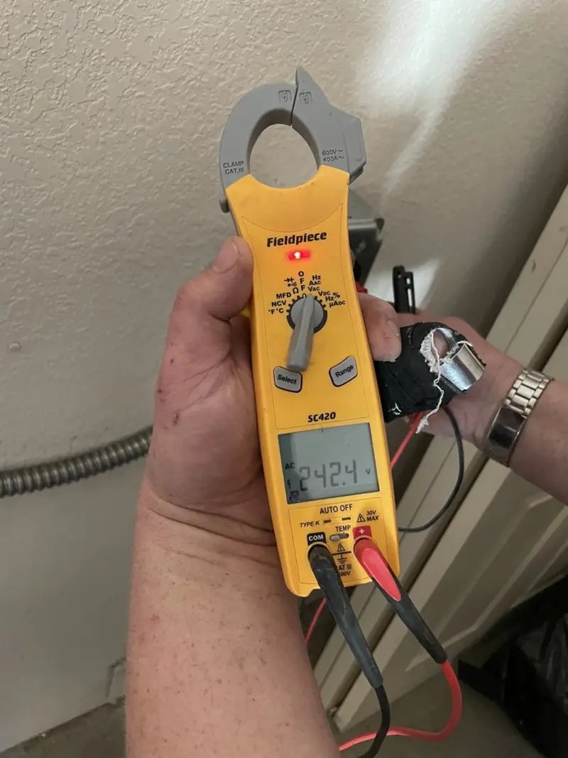 Voltage testing with clamp meter during Ceiling Fan Installation in Benson